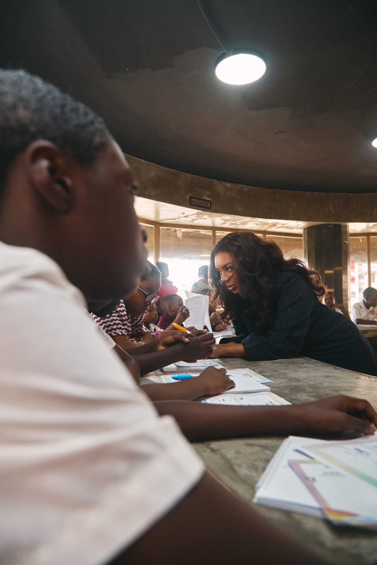 A facilitator listening to a young writer one on one